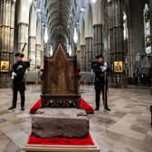 King's Bodyguards for Scotland and members of Royal Company of Archers Alex Baillie-Hamilton (L) and Paul Harkness (R) stand guard by the Stone of Destiny Westminster Abbey during a welcome ceremony on April 29, 2023 in London, England.  The stone, an ancient symbol of Scotland's monarchy, will play a central role in the Coronation of The King in the Abbey on Saturday 6th May. In 1296, King Edward I brought the stone to Westminster. He placed it within the Coronation Chair, the oak seat he commissioned in 1300-1301 and which has been the centre piece of coronations for more than 700 years. In 1996, the UK government announced that the stone would return to Scotland, but would come back to the Abbey for coronations. (Photo by Susannah Ireland - Pool/Getty Images)
