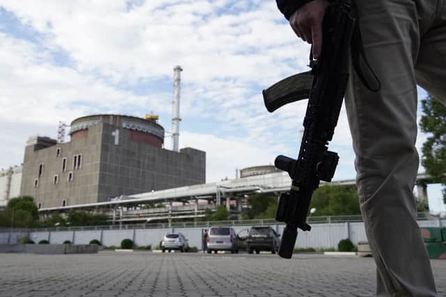 A security person standing in front of the Zaporizhzhia Nuclear Power Plant. Picture: STRINGER/AFP via Getty Images
