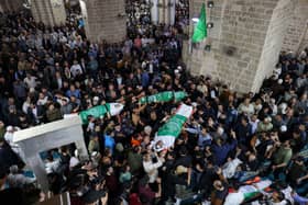 Hundreds of mourners attend a group funeral in Gaza City for people killed in Israeli air raids in the Palestinian territory on May 9 (Photo by MOHAMMED ABED/AFP via Getty Images)