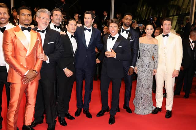 Glen Powell, Greg Tarzan Davis, Christopher McQuarrie, Jon Hamm, Danny Ramirez, Joseph Kosinski, Tom Cruise, Jay Ellis, Jennifer Connelly and    leave the screening of "Top Gun: Maverick" during the 75th annual Cannes film festival at Palais des Festivals on May 18, 2022 in Cannes, France. (Photo by Andreas Rentz/Getty Images)