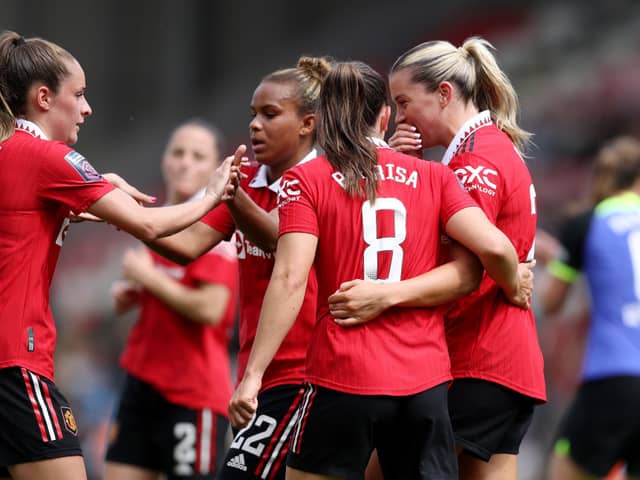 Alessia Russo celebrates scoring against Spurs with Manchester United