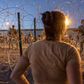 Texas National Guard soldiers block entry for more migrants to enter a makeshift camp near the U.S.-Mexico border fence on May 11, 2023 in El Paso, Texas. A surge of immigrants is expected with the end of Title 42 . Credit: Getty Images