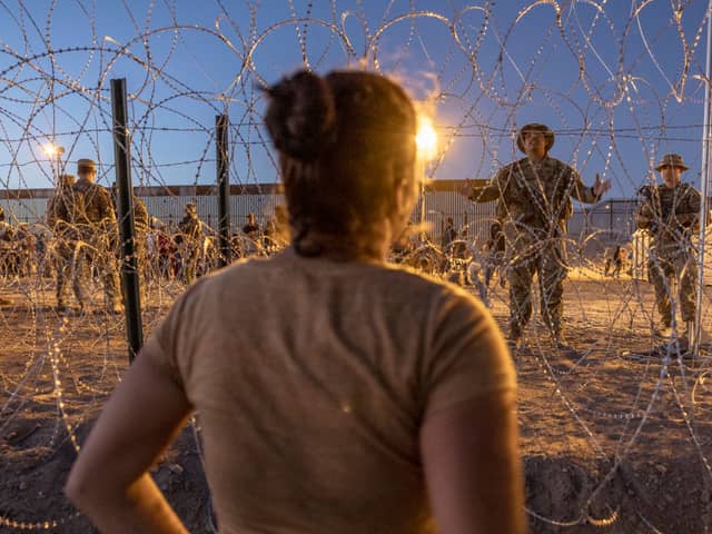 Texas National Guard soldiers block entry for more migrants to enter a makeshift camp near the U.S.-Mexico border fence on May 11, 2023 in El Paso, Texas. A surge of immigrants is expected with the end of Title 42 . Credit: Getty Images