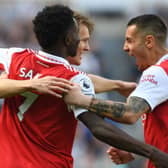 Arsenal captain Martin Odegaard celebrates scoring with Bukayo Saka and Jakub Kiwior 