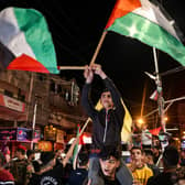 Palestinians celebrate in the street after a ceasefire was agreed in Gaza. Picture: MOHAMMED ABED/AFP via Getty Images