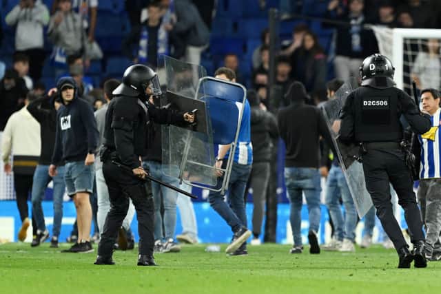 Riot police were deployed as Espanyol fans ran on to the pitch
