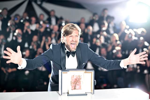 Swedish film director and screenwriter Ruben Ostlund poses with the trophy during a photocall after he won the Palme d'Or for the film "Triangle of Sadness" (Credit: Getty Images)