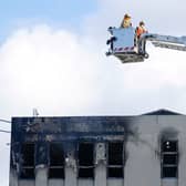Firefighters survey the roof after the deadly fire at Loafers Lodge in Wellington (Photo by Hagen Hopkins/Getty Images)