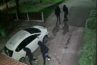Video grab of four masked men entering from Mohammed Ali's Oldham home, in what he reported was a terrifying home invasion (Mohammed Ali / SWNS)