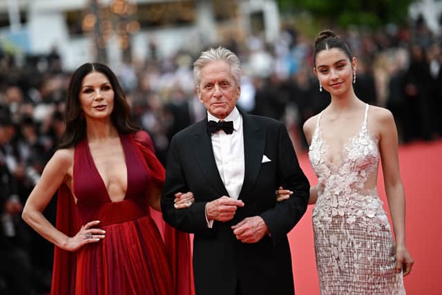 US actor and Honorary Palme d'or of the 76th Festival de Cannes Michael Douglas (C) arrives with his wife British actress Catherine Zeta-Jones (L) and daughter Carys for the opening ceremony and the screening of the film "Jeanne du Barry" during the 76th edition of the Cannes Film Festival in Cannes, southern France, on May 16, 2023. (Photo by LOIC VENANCE / AFP) (Photo by LOIC VENANCE/AFP via Getty Images)