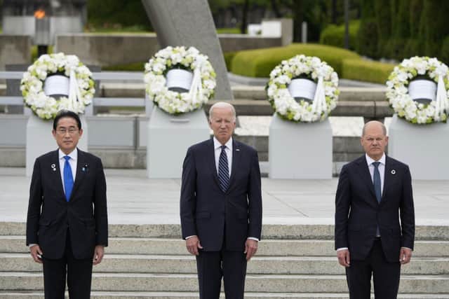 (L-R) Japanese Prime Minister Fumio Kishida, U.S. President Joe Biden and German Chancellor Olaf Scholz pose for a group photo after laying flower wreaths at the Cenotaph for Atomic Bomb Victims in the Peace Memorial Park on the sidelines of the G7 summit on May 19, 2023 in Hiroshima, Japan. (Photo by Franck Robichon - Pool/Getty Images)