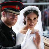 TOPSHOT - Britain's Prince Harry, Duke of Sussex and his wife Meghan, Duchess of Sussex wave from the Ascot Landau Carriage during their carriage procession on the Long Walk as they head back towards Windsor Castle in Windsor, on May 19, 2018 after their wedding ceremony. (Photo by Aaron Chown / POOL / AFP)        (Photo credit should read AARON CHOWN/AFP via Getty Images)