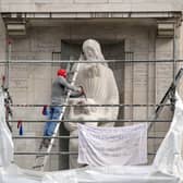 A man wearing a Spiderman mask uses a hammer and chisel to damage the Prospero and Ariel statue by Eric Gill, outside BBC Broadcasting House in London. Picture: Jonathan Brady/PA Wire