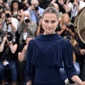 Alicia Vikander attending Cannes Film Festival 2023, where her starring role as Catherine Parr (inset) earned her a standing ovation after the premiere of Firebrand (Credit: Getty Images)