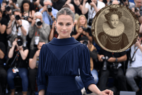 Alicia Vikander attending Cannes Film Festival 2023, where her starring role as Catherine Parr (inset) earned her a standing ovation after the premiere of Firebrand (Credit: Getty Images)