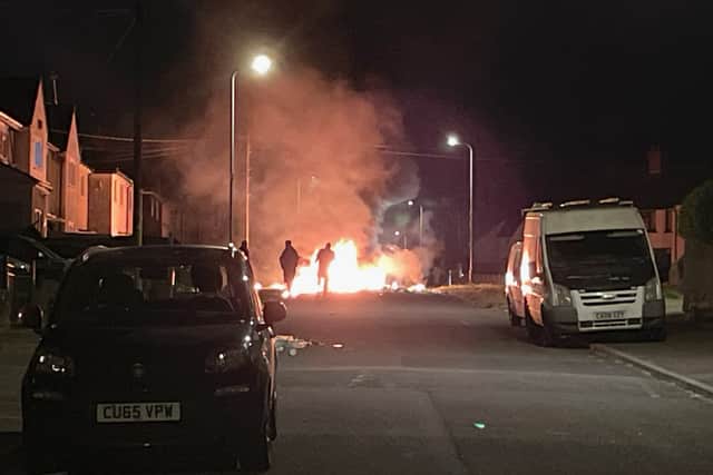 Scenes being live streamed on YouTube showed youths throwing fireworks and other missiles at a line of police officers with riot shields who were blocking one end of the street. (Photo: Bronwen Weatherby/PA Wire)