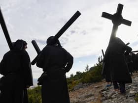 Penitents carry crosses during the "Romeria a la Trinidad" pilgrimage in the village of Lumbier on June 12, 2022. - The pilgrimage of Lumbier is a penitential celebration that takes place every year on Sunday of the Holy Trinity