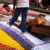 People arrange a carpet of flowers to mark the Corpus Christi feast in the town of La Orotava, on the Spanish Canary Island of Tenerife, on June 26, 2014