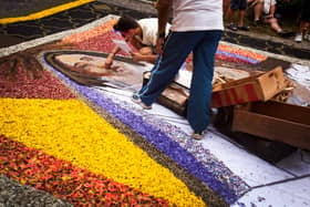 People arrange a carpet of flowers to mark the Corpus Christi feast in the town of La Orotava, on the Spanish Canary Island of Tenerife, on June 26, 2014