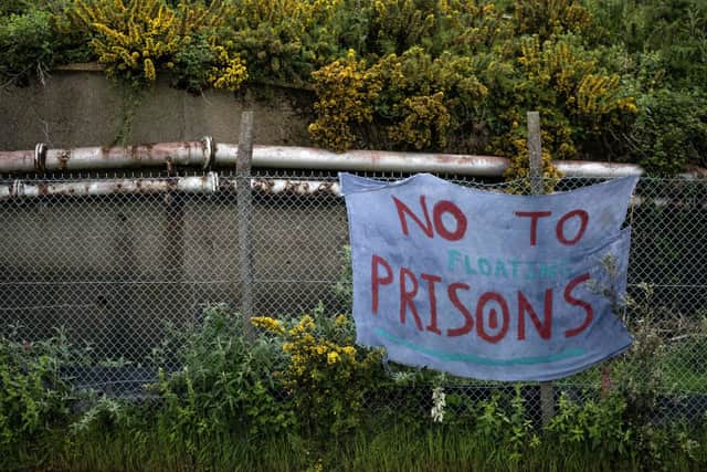 A banner reads “no to floating prisons” in protest against the Bibby Stockholm, a barge where the government last month announced plans to house around 500 asylum seekers. Credit: Getty Images
