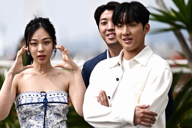 (From L) South Korean singer and actress Kim Hyung-Seo aka Bibi, South Korean director Kim Chang-hoon and South Korean actor Hong Sa-bin arrive to attend a photocall for the film "Hwa-Ran" (Hopeless) at the 76th edition of the Cannes Film Festival in Cannes, southern France, on May 25, 2023. (Photo by LOIC VENANCE / AFP) (Photo by LOIC VENANCE/AFP via Getty Images)