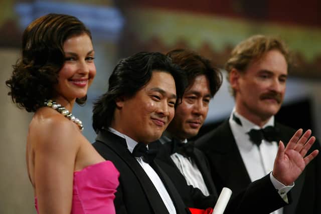 South Korean director Park Chan-Wook (2L) and actor Choi Min Sik (2R) pose with US actress Ashley Judd (L) and US actor Kevin Kline (R) after they won the Grand Prize for the film 'Old Boy' onstage during the Closing Ceremony at the 57th Cannes Film Festival on May 22, 2004 in Cannes, France. (Photo by Bruno Vincent/Getty Images)