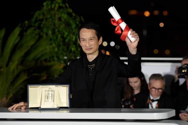CANNES, FRANCE - MAY 27: Tran Anh HÃ¹ng poses with The Best Director Award for 'La Passion De Dodin Bouffant' (The Pot-Au-Feu) during the Palme D'Or winners photocall at the 76th annual Cannes film festival at Palais des Festivals on May 27, 2023 in Cannes, France. (Photo by Kristy Sparow/Getty Images)