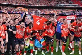 Players of Luton Town hold shirt with name of captain Tom Lockyer on. Picture: Richard Heathcote/Getty Images