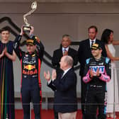 Max Verstappen lifts his trophy with Alonso and Ocon celebrating their second and third positions respectively