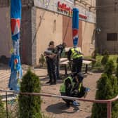 Police officers work at the site where a building was damaged during a Russian drone attack in Kyiv. (Credit: Getty Images)