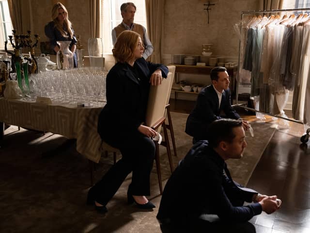 Justine Lupe as Willa Ferreyra, Alan Ruck as Connor Roy, Sarah Snook as Shiv Roy, Jeremy Strong as Kendall Roy, and Kieran Culkin as Roman Roy in Succession, watching old footage of their father (Credit: HBO)