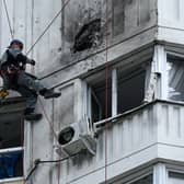 A specialist inspects the damaged facade of a multi-storey apartment building after a reported drone attack in Moscow (Photo: KIRILL KUDRYAVTSEV/AFP via Getty Images)