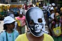 A school children wearing a facemask of a skull with a cigarette takes part in an awareness rally against the use of tobacco on 'World No Tobacco Day' in Kolkata on May 31, 2023.