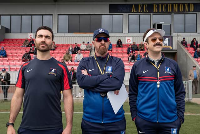Brett Goldstein as Roy Kent, Brendan Hunt as Coach Beard, and Jason Sudeikis as Ted Lasso in Ted Lasso (Credit: Apple TV+)