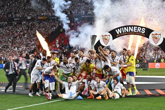 Sevilla lift their seventh Europa League trophy at the Puskas Arena last night