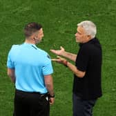 Jose Mourinho speaks with fourth official Michael Oliver in UEFA Europa League final 