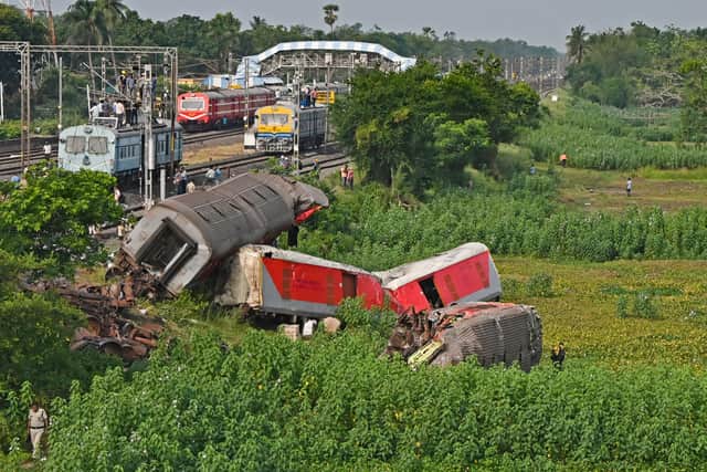 Wrecked carriages at the accident site of a train crash near Balasore, in India