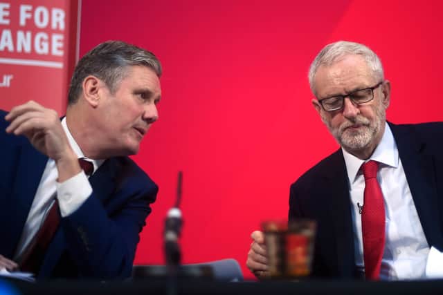 Keir Starmer and Jeremy Corbyn talk onstage during a campaign speech on December 6, 2019 in London, England. Credit: Getty Images