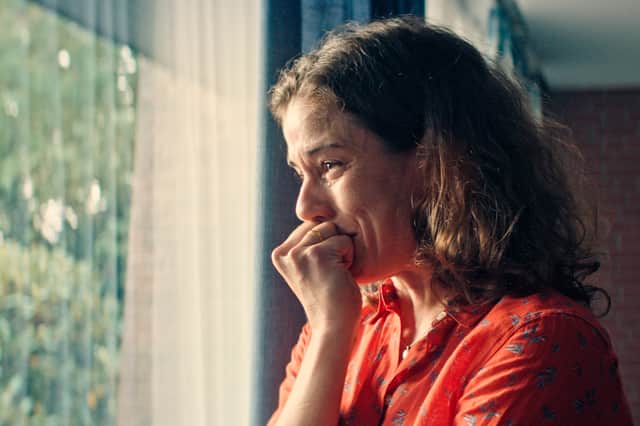 Alexandra Gottschlich as Ariane Lemmes in The Marnow Murders, crying by the window (Credit: Walter Presents/NDR/Polyphon/Philipp Sichler)