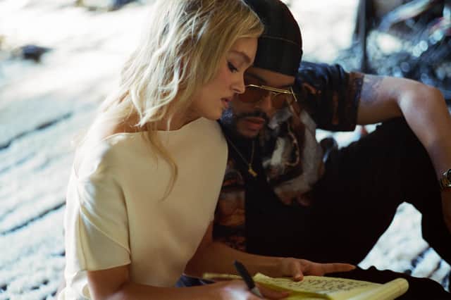 Lily-Rose Depp as Jocelyn and Abel Tesfaye as Tedros in The Idol, reading through handwritten notes in a journal (Credit: HBO)