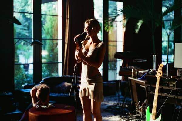 Lily-Rose Depp as Jocelyn in The Idol, singing into a microphone in a home recording studio (Credit: HBO)