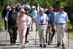 Britain's King Charles III (C) walks down a street in the village of Valea Zalanului, 250 kilometers north of Bucharest, on June 3, 2023. Britain's King Charles III is on a solo visit in the eastern European country. Charles' trip to Romania is his first abroad since he was crowned king on May 6, 2023. (Photo by MIHAI BARBU / AFP) (Photo by MIHAI BARBU/AFP via Getty Images)