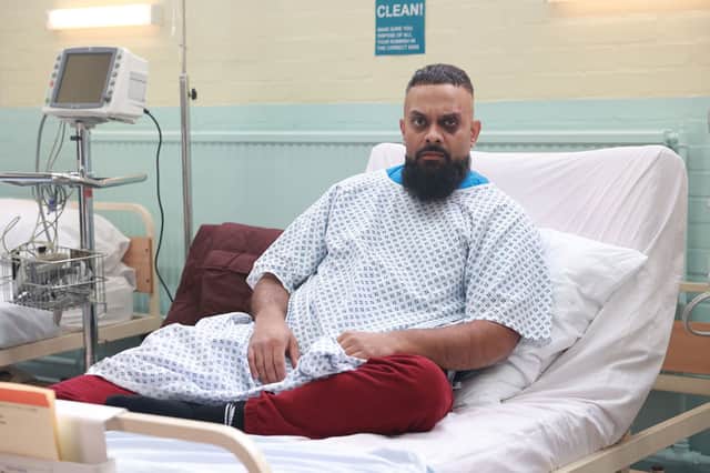Guz Khan as Mobeen in Man Like Mobeen S4, wearing a hospital gown in bed (Credit: BBC/Tiger Aspect)