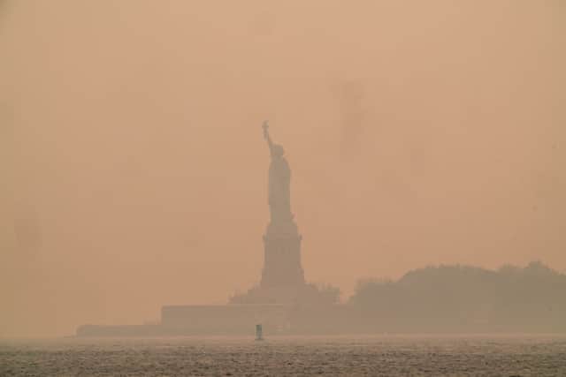 A smoky haze from wildfires in Canada envelops the Statue of Liberty (Photo: Getty Images)