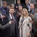 Michael Sheen as Andrew and Sharon Horgan as Nicci in Best Interests, surrounded by press outside court (Credit: BBC/Chapter One/Kevin Baker)