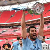 Manchester City's German midfielder Ilkay Gundogan celebrates with the trophy on the pitch after the English FA Cup final football match between Manchester City and Manchester United at Wembley stadium, in London, on June 3, 2023. Man City won the game 2-1. (Photo by Glyn KIRK / AFP) / NOT FOR MARKETING OR ADVERTISING USE / RESTRICTED TO EDITORIAL USE (Photo by GLYN KIRK/AFP via Getty Images)