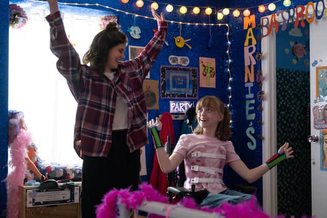Alison Oliver as Katie and Niamh Moriarty as Marnie in Best Interests, arms raised in Marnie's bedroom (Credit: BBC/Chapter One/Samuel Dore)