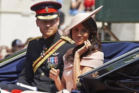 TOPSHOT - Britain's Prince Harry, Duke of Sussex and Britain's Meghan, Duchess of Sussex return in a horse-drawn carriage after attending the Queen's Birthday Parade, 'Trooping the Colour' on Horseguards parade in London on June 9, 2018. - The ceremony of Trooping the Colour is believed to have first been performed during the reign of King Charles II. In 1748, it was decided that the parade would be used to mark the official birthday of the Sovereign. More than 600 guardsmen and cavalry make up the parade, a celebration of the Sovereign's official birthday, although the Queen's actual birthday is on 21 April. (Photo by Niklas HALLE'N / AFP) (Photo by NIKLAS HALLE'N/AFP via Getty Images)