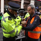 Police make arrests as Just Stop Oil protesters walk down Shaftesbury Avenue on June 7. (Photo by Dan Kitwood/Getty Images)
