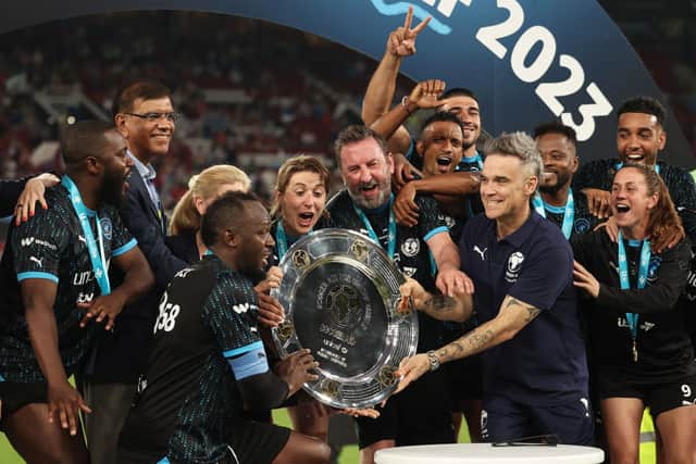 Robbie Williams, Manager of World XI awards the Soccer Aid winners shield to Players of World XI following Soccer Aid for Unicef 2023 at Old Trafford on June 11, 2023 in Manchester, England. (Photo by Matt McNulty/Getty Images)